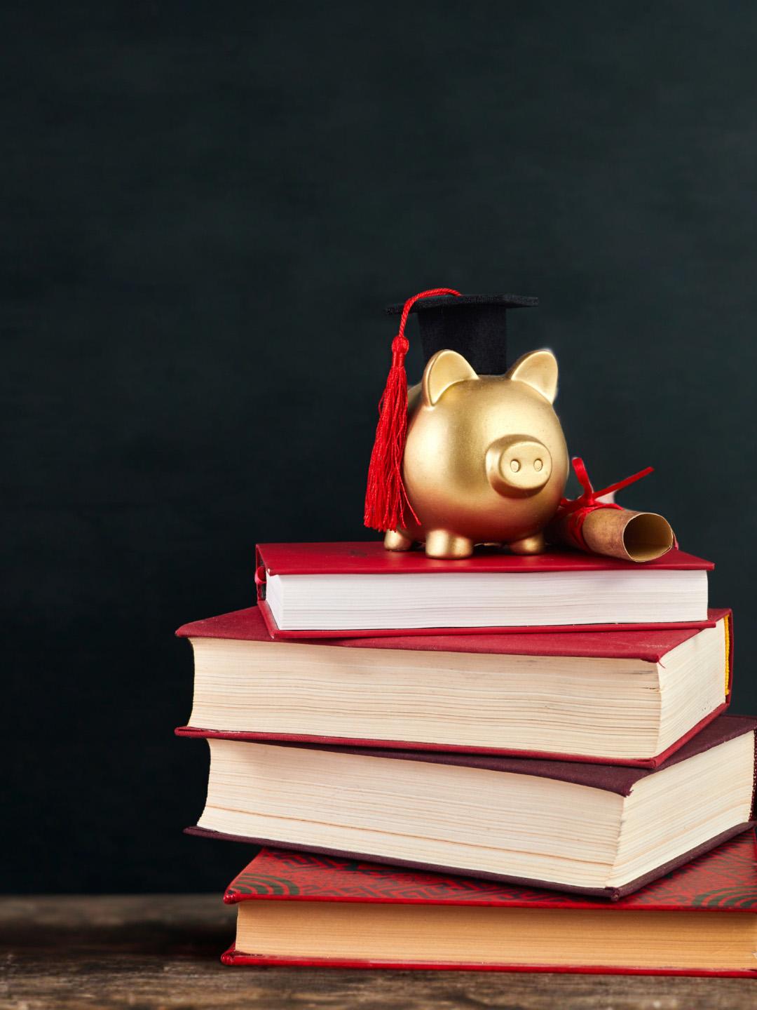A piggy bank on a stack of text books
