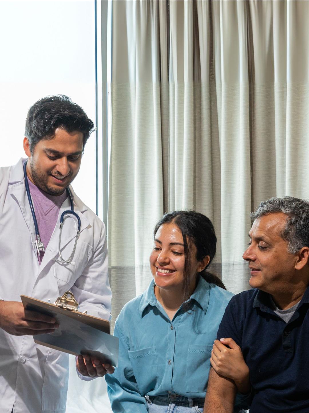 Doctor speaking to a man and woman