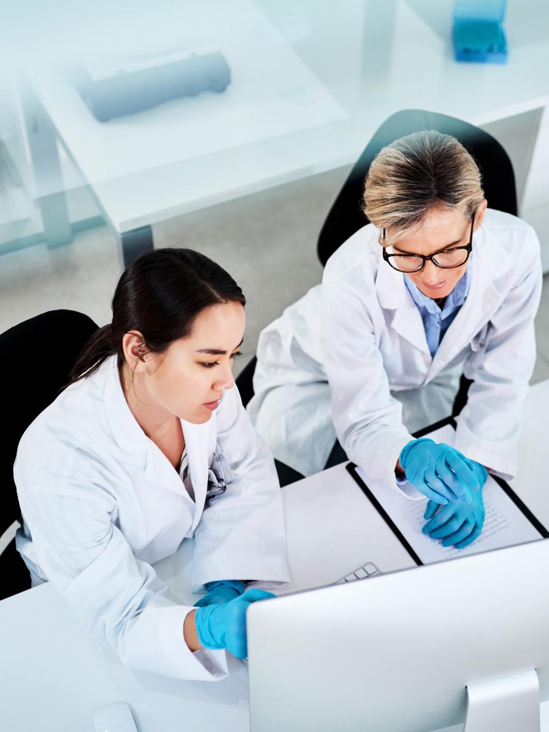 Two researchers in a lab looking at a computer screen