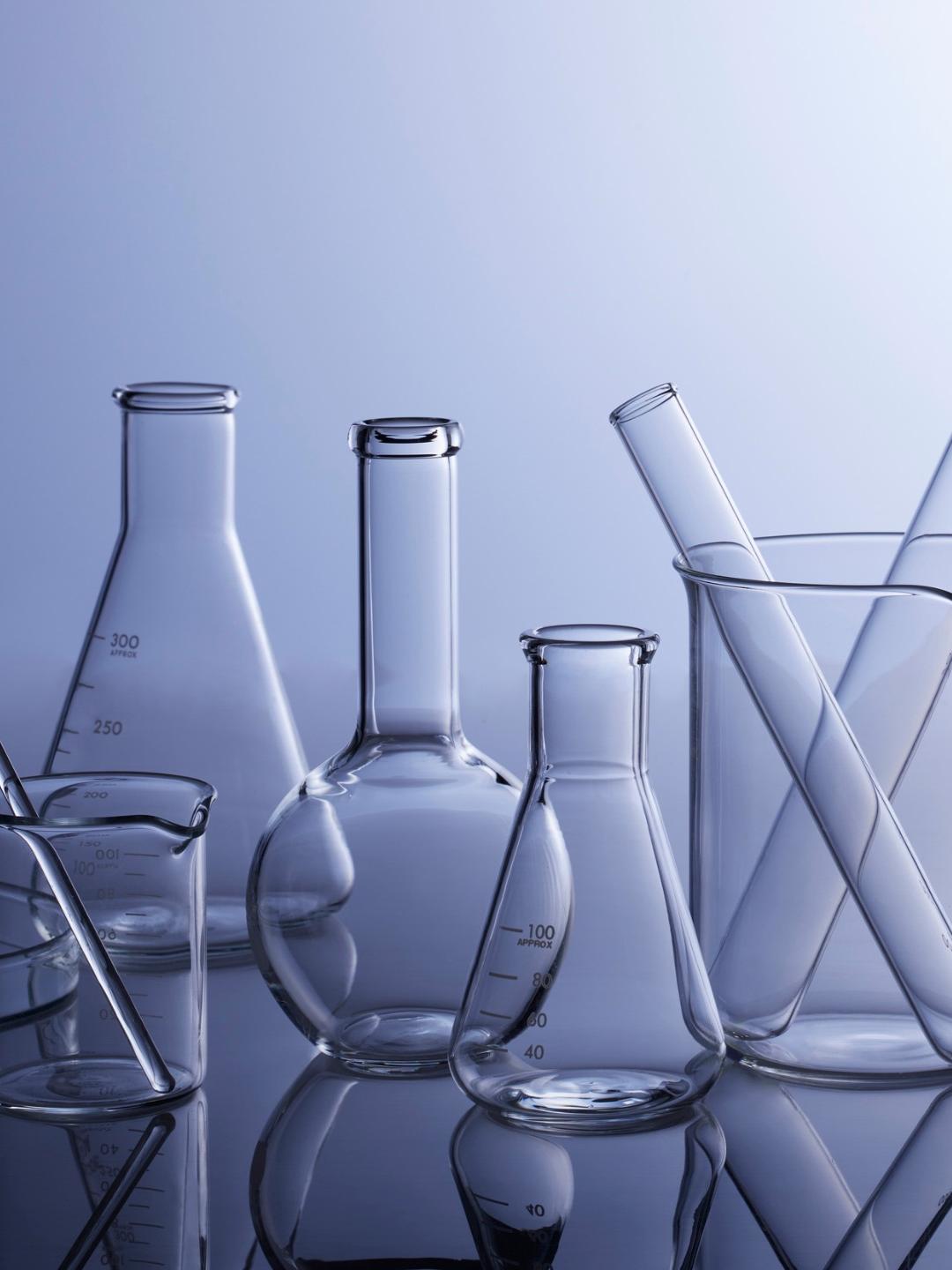 Beakers, Erlenmeyer flasks, test tubes, and burrettes on a table