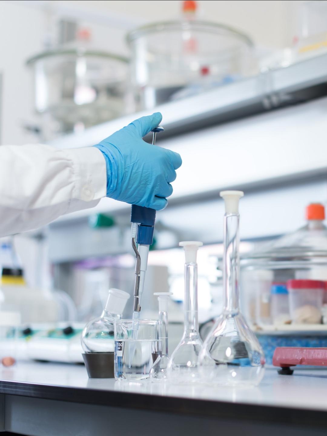 A researcher in a lab in front of equipment