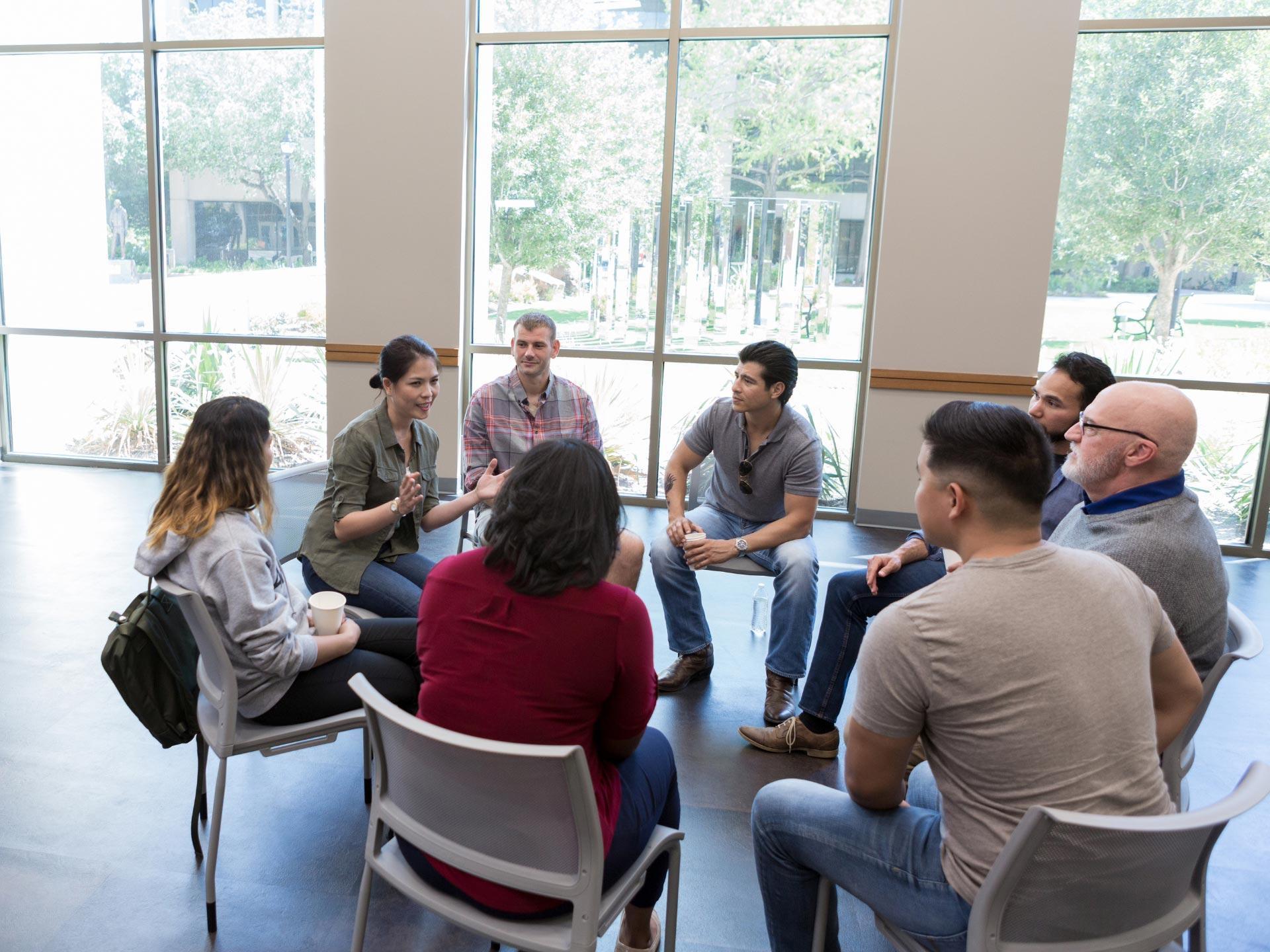 A group of people discussing mental health