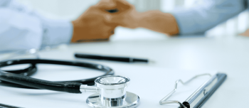 a close up picture of a stethoscope lying on a clipboard