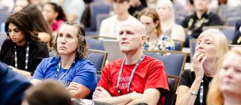 People listening intently to session about research