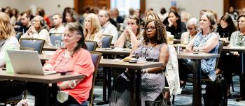 People listening to session about research