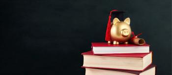 A piggy bank on a stack of text books