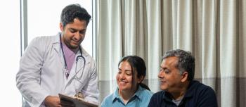 Doctor speaking to a man and woman