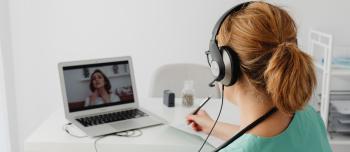 A woman watching a webinar A woman watching a webinar