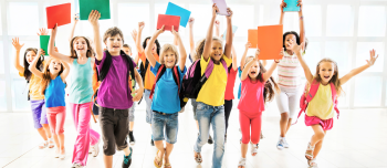 kids back to school smiling and running with book in hand