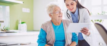 Doctor and woman looking at computer screen in doctors office