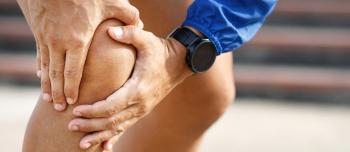 Male with Knee pain and smartwatch