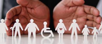 A pair of hands with cutouts of people A pair of hands with cutouts of people