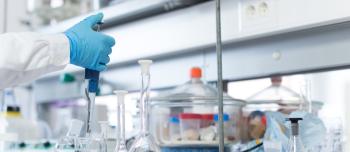 A researcher in a lab in front of equipment A researcher in a lab in front of equipment
