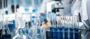 Test tubes, vials, microscope in a lab conducting research