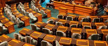 A room where politicians meet with several empty seats