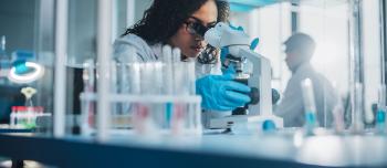 A woman using a microscope for research