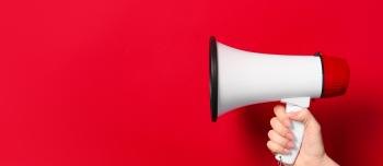 A hand holding a megaphone with a red background