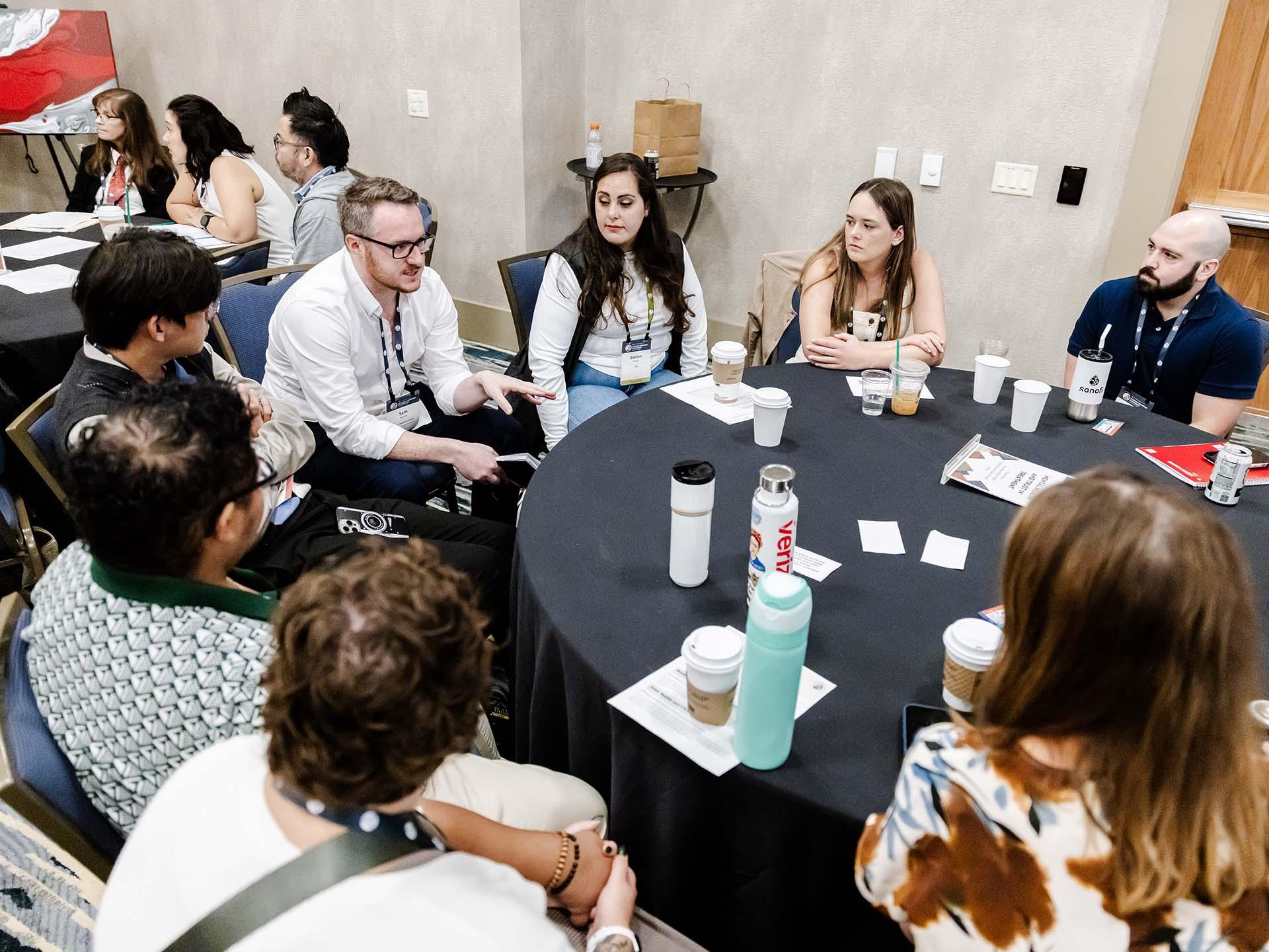 People at a table speaking