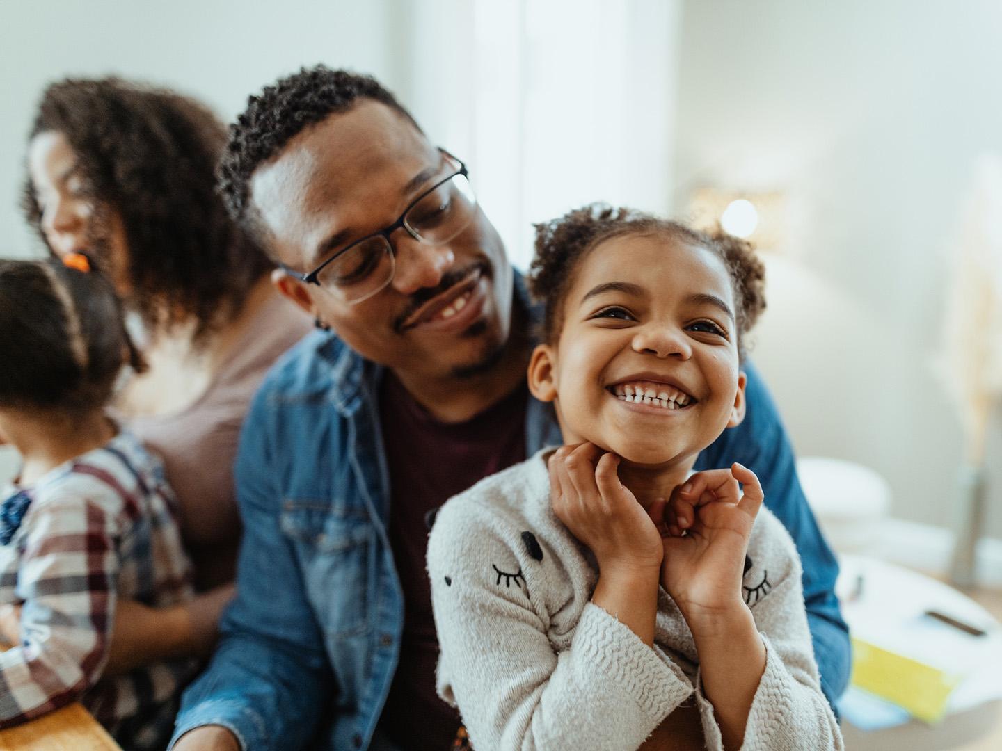 A father holding his daughter.