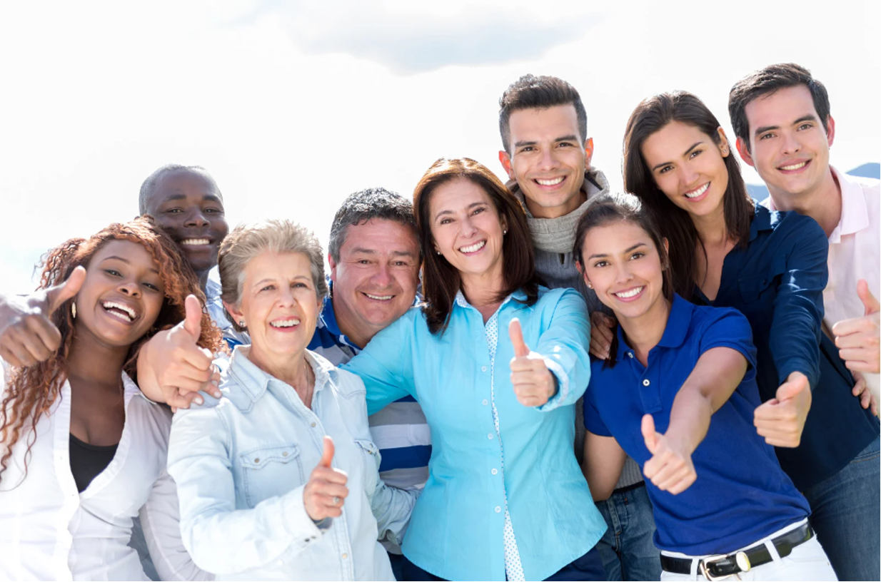 A group of people smiling together while having their picture taken