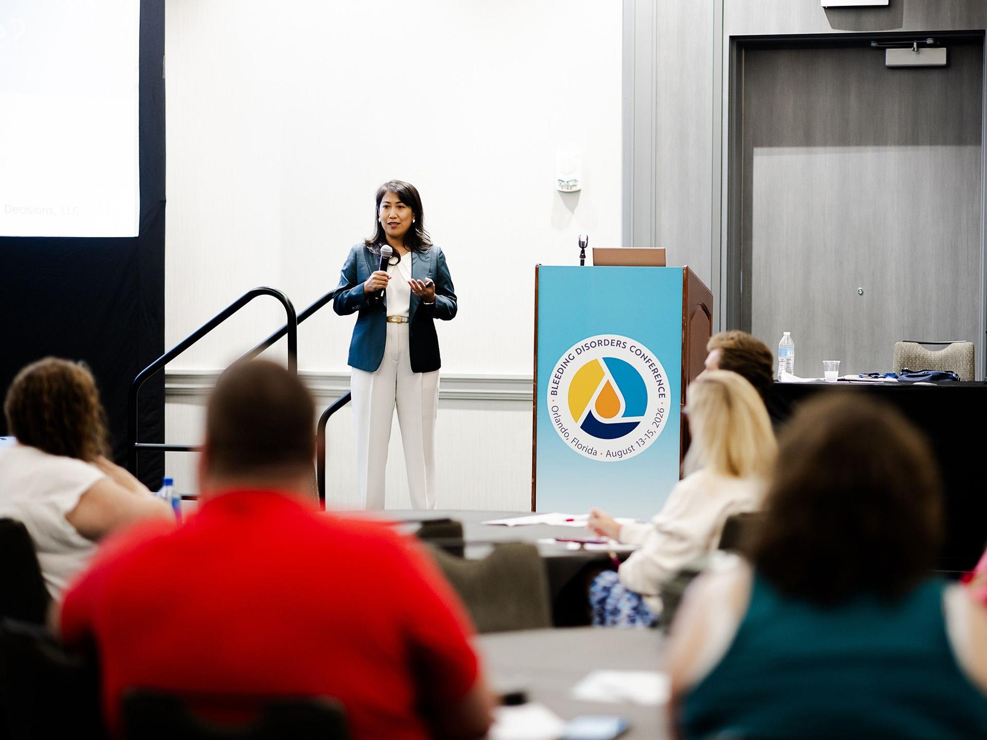 A woman speaking at a podium